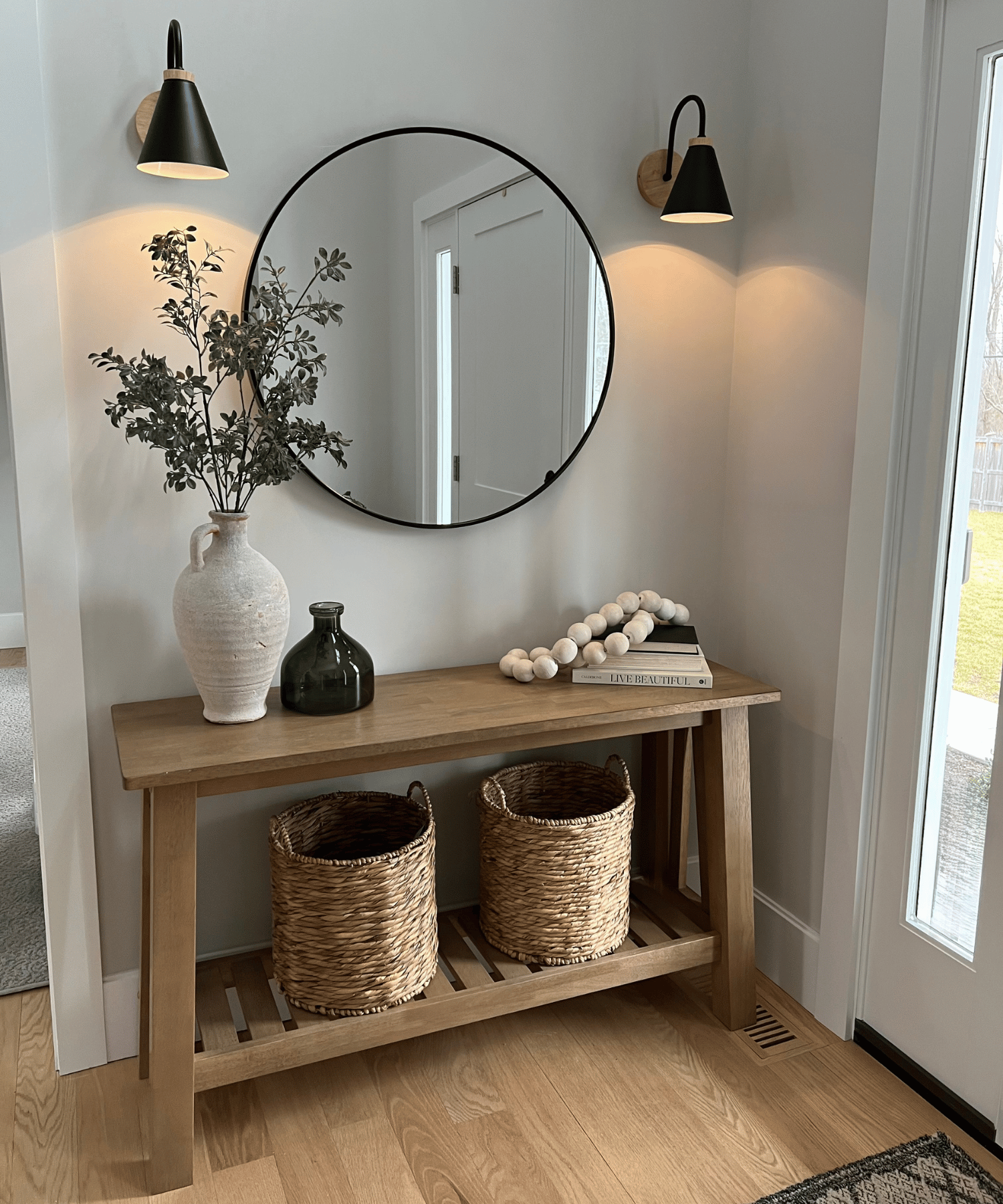 A polished entryway featuring thoughtful styling