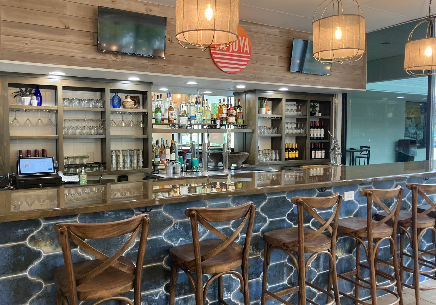 Lively bar interior designed by HB Stevens featuring vibrant décor and strategic seating