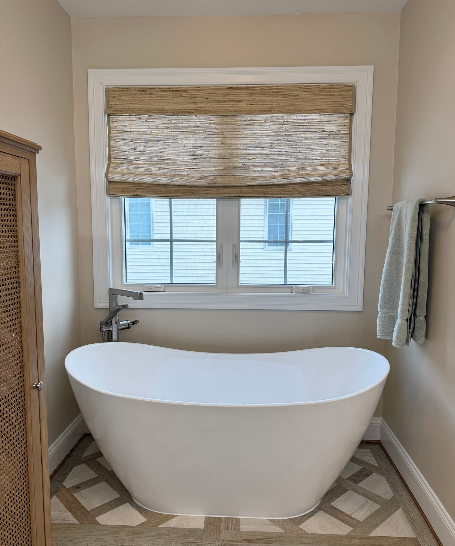 Neutral bathroom featuring a sleek freestanding tub